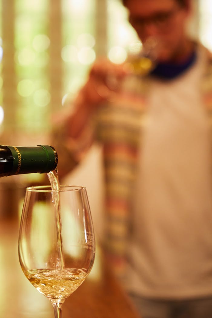 Close-up of champagne being poured with blurred background for a classy touch.